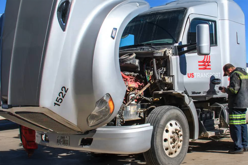 Mobile mechanic running diagnostics on truck